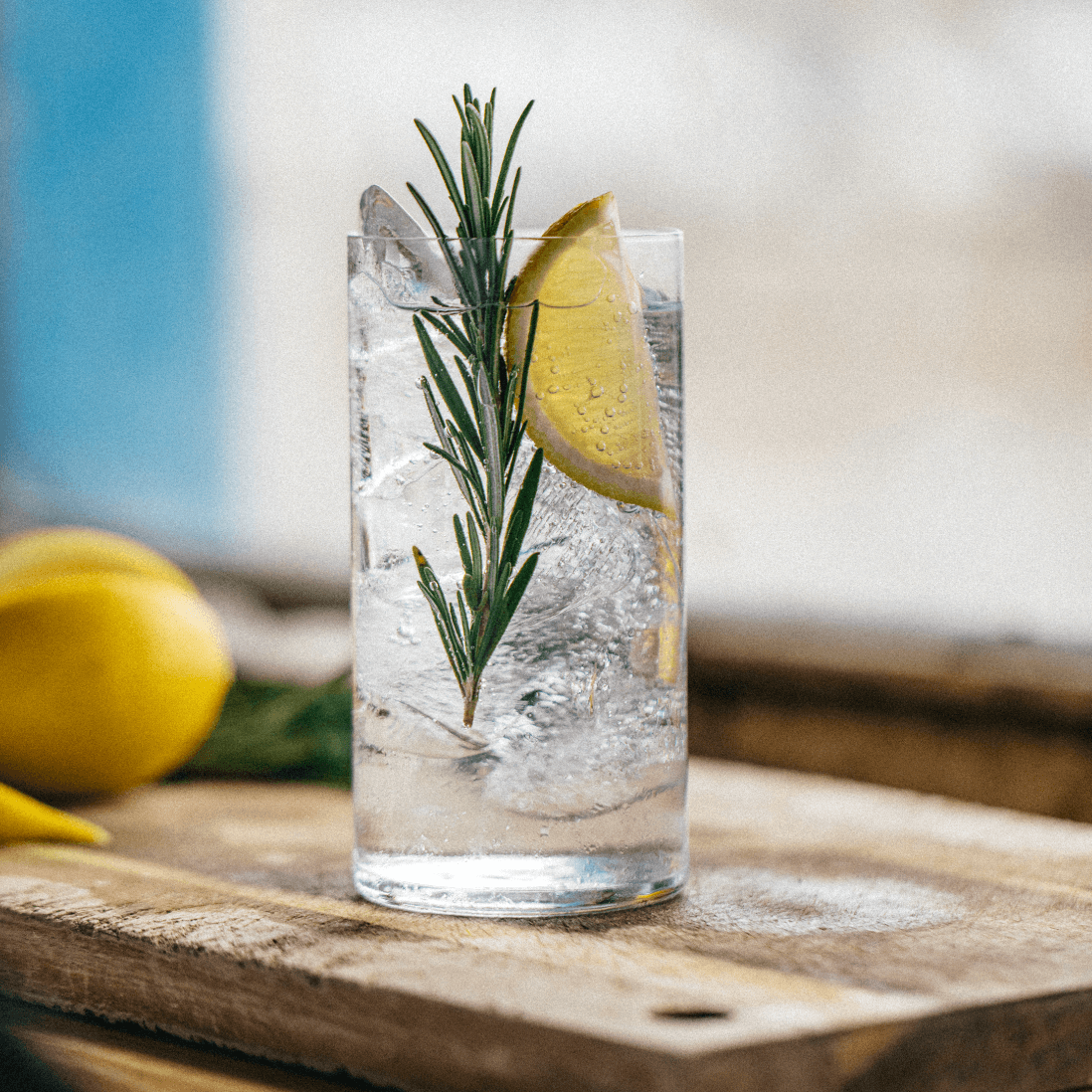 Pentire Adrift cocktail garnished with rosemary and lemon, served cold in a tall glass.