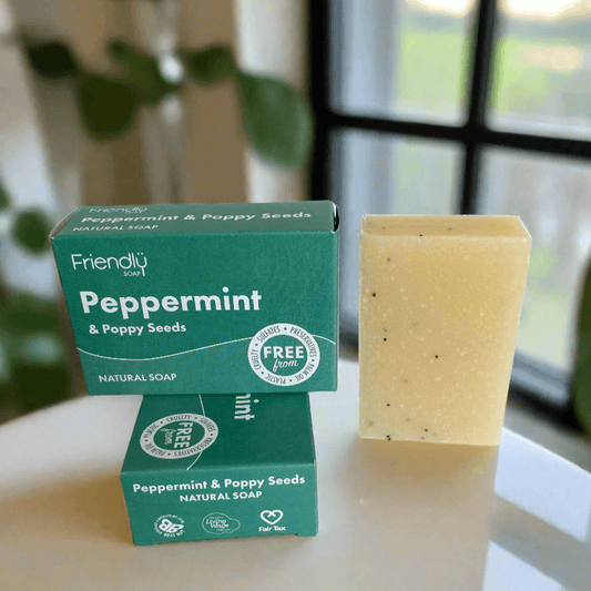 Two boxes of Friendly Soap with peppermint and poppy seeds, one bar of soap on a white background.