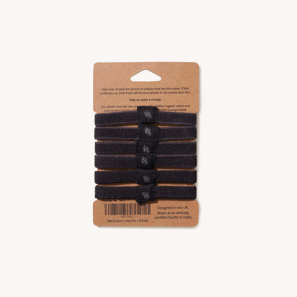 Set of black hair ties on a cardboard packaging with text and a barcode.