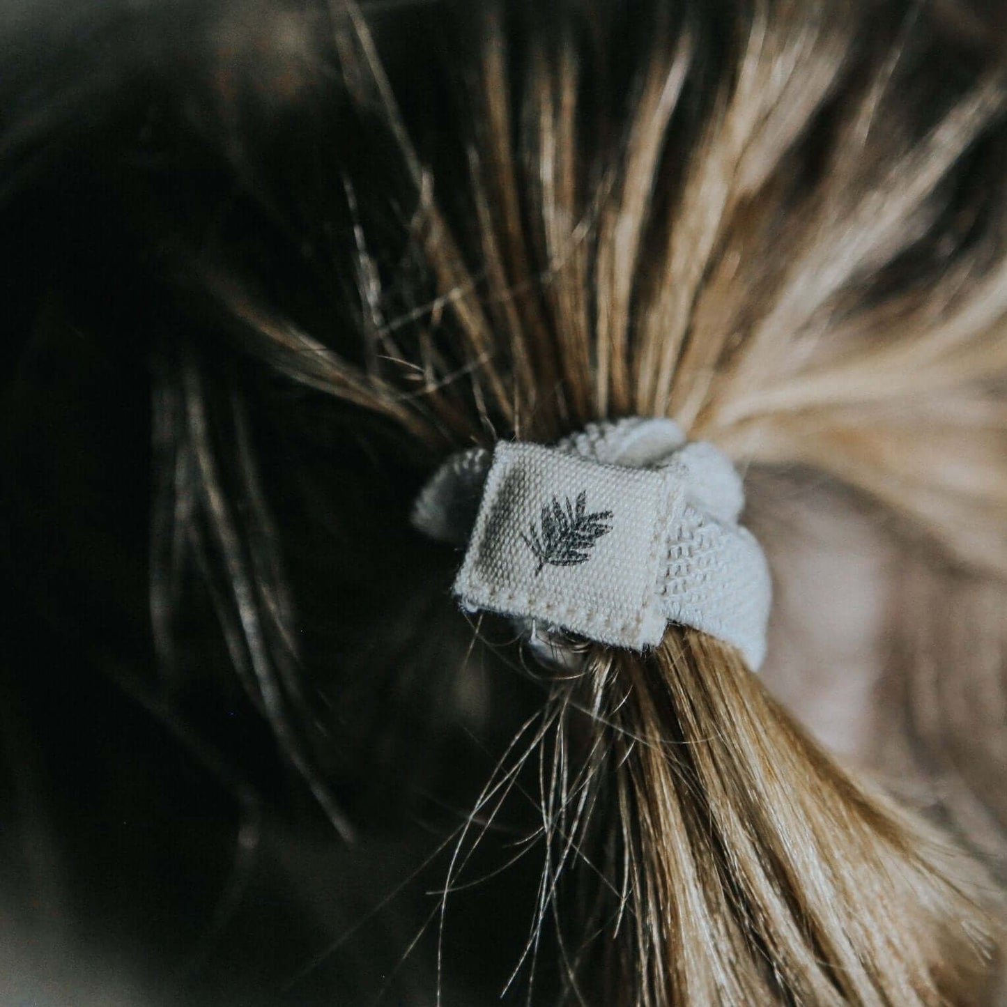 Plastic Free Hair Ties - 6 Pack - Black on a ponytail showcasing eco-friendly hair accessories.