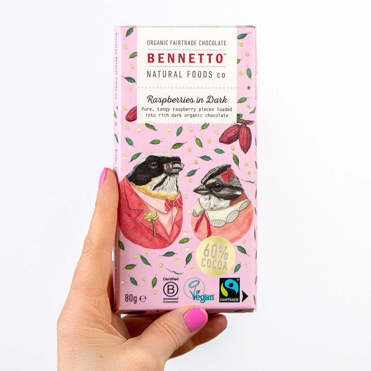 Raspberries in Dark chocolate packaging held in hand featuring eco-friendly design and Fairtrade certification.