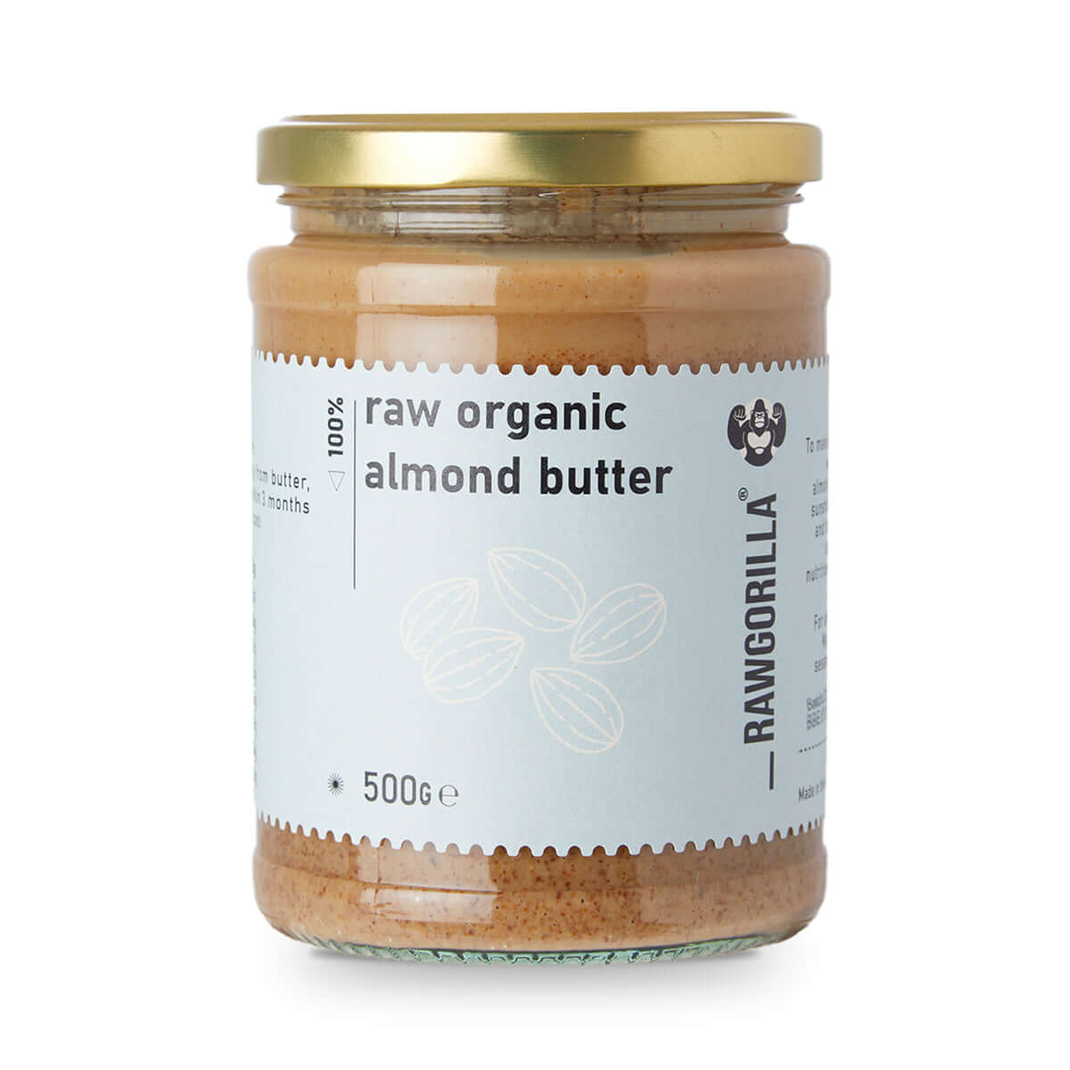 Jar of raw organic almond butter with a gold lid on a white background