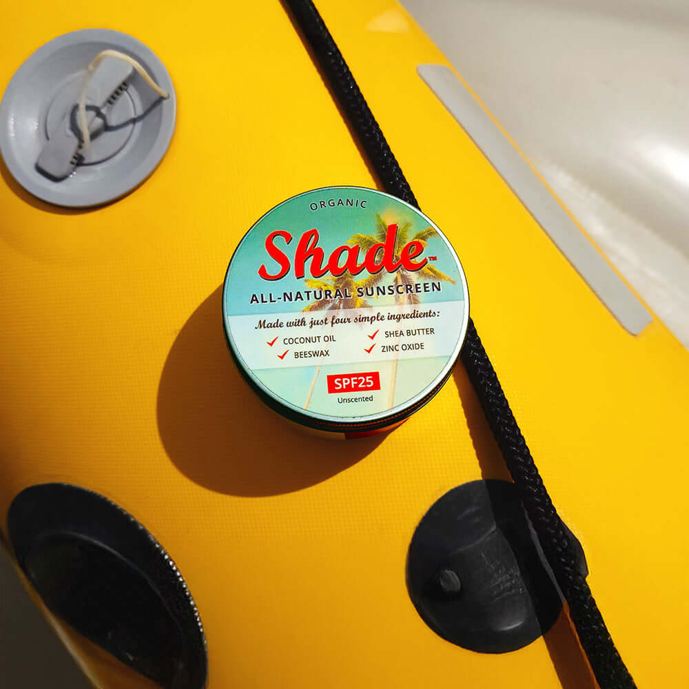 Shade all-natural sunscreen container on a yellow surface