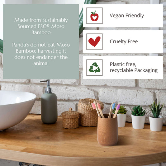 Bathroom setting with bamboo products and sustainability information on a wooden surface.