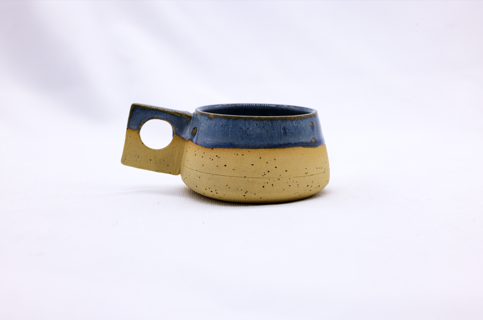 TerraBlu Formo Handmade Ceramic Stoneware Coffee Mug showcasing unique design and earthy colors.