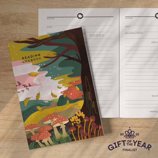 Reading logbook with colorful mushroom design on a wooden surface