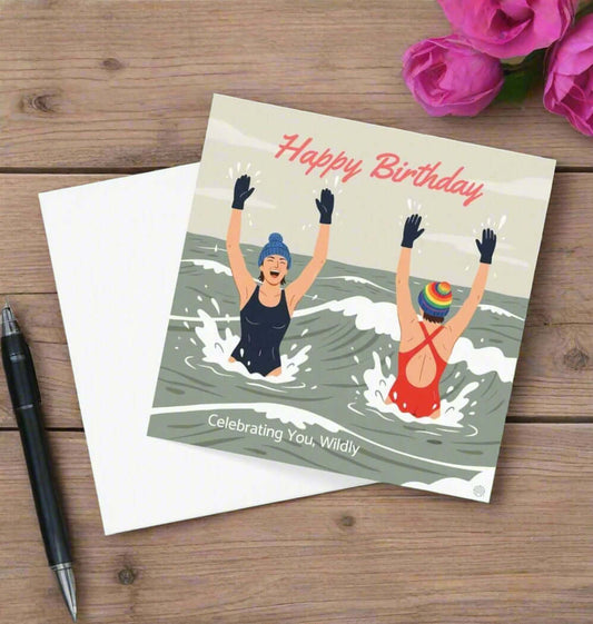 Birthday card with illustration of two people in the water, text 'Happy Birthday' and 'Celebrating You, Wildly'.