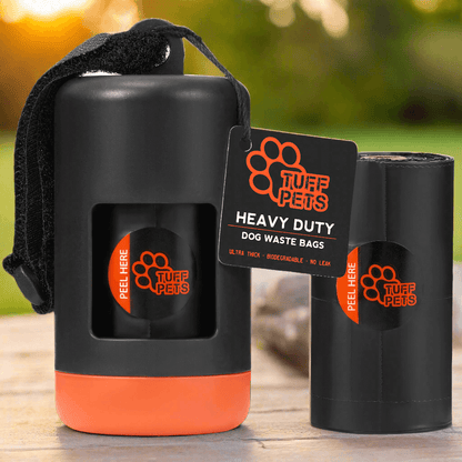 Black and orange dog waste bag dispenser with Tuff Pets branding on a clear background