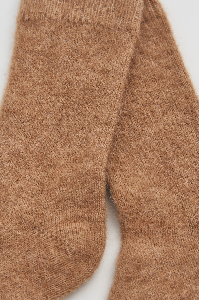 Alpaca Bed Socks made of ultra-soft fabric in a warm beige color.