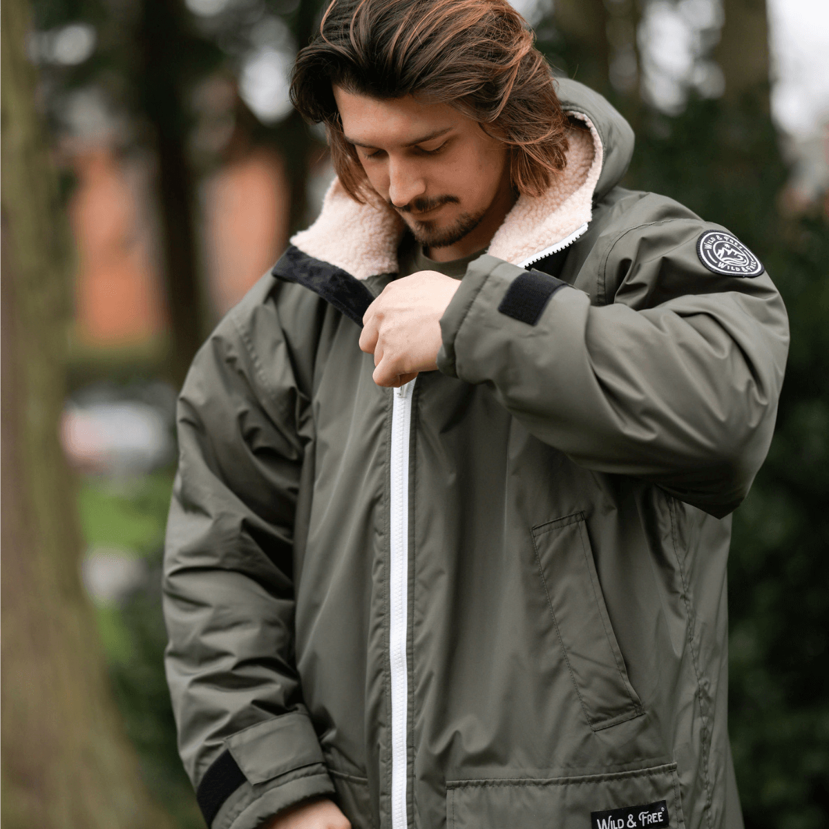 Raincoat & Changing Robe in One - The Classic Cobe Olive Green worn by a man outdoors, showcasing its cozy design and features.