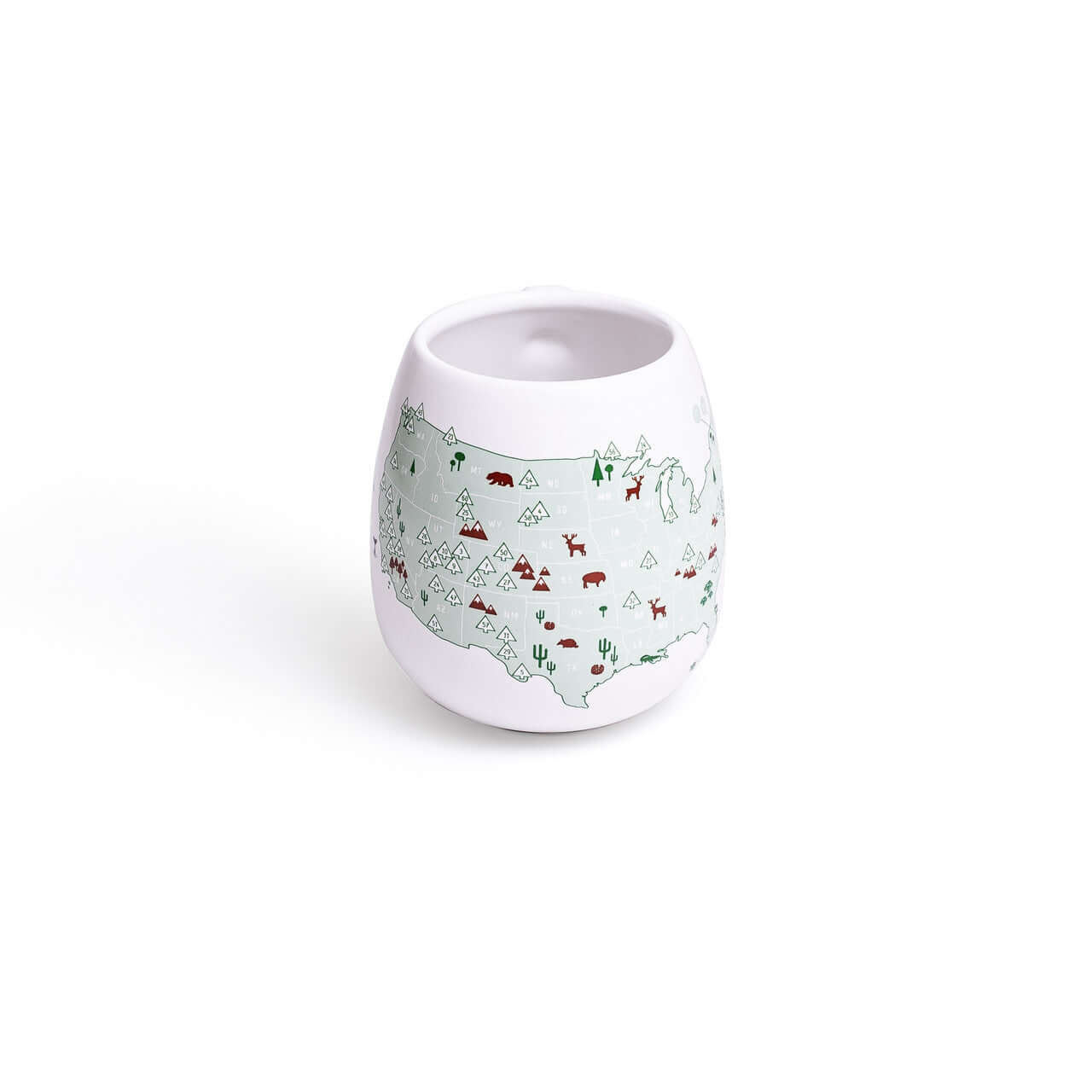 White ceramic cup with nature-themed design on a white background