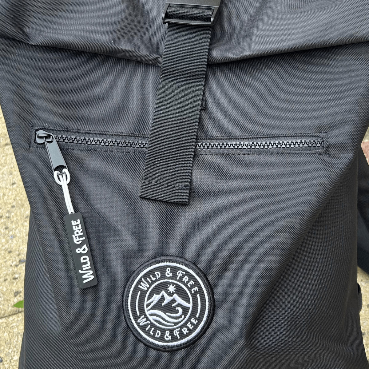 The Backpack features a zipped pocket and Wild & Free logo, perfect for adventures. Shop at Alewk.club.