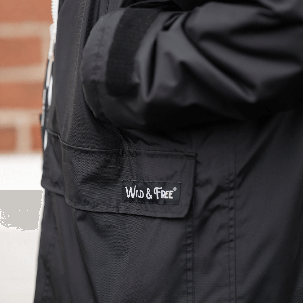 Raincoat & Changing Robe in One - The Classic Cobe Black featuring Wild & Free branding.