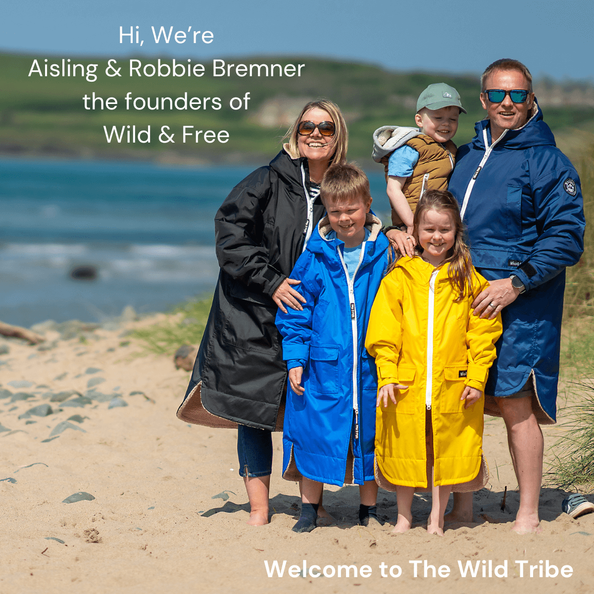 A family wearing colorful raincoats on the beach, founders of Wild & Free, promoting outdoor adventures.