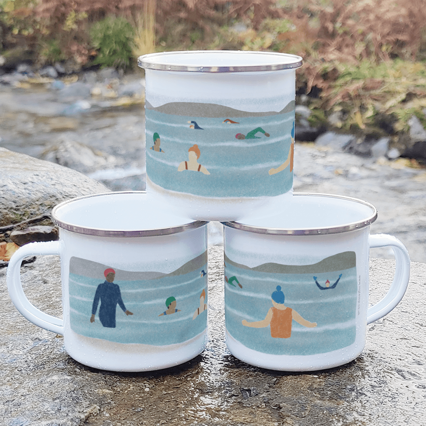 Wild Swimming Enamel Mug featuring playful swimmers taking a dip in refreshing water.