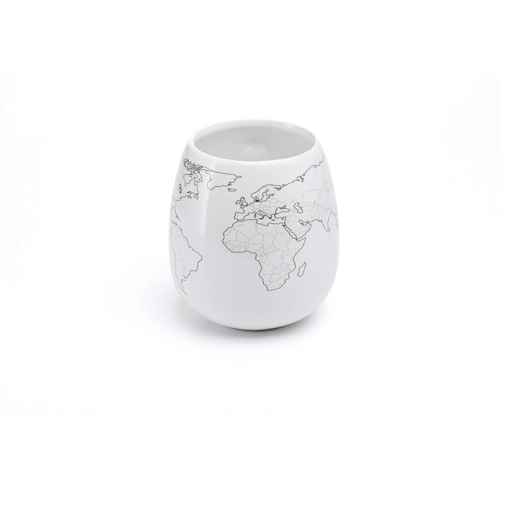 White ceramic cup with world map design on a white background
