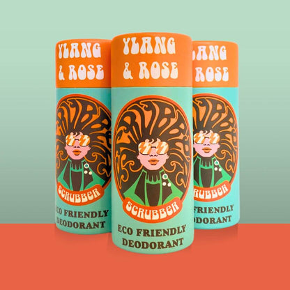 Three Scrubber Ylang and Rose natural deodorant sticks in orange and turquoise tubes